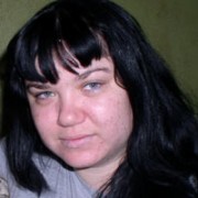 Young woman with dark hair and bangs